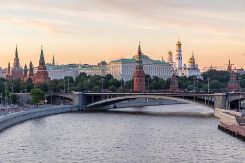 Moscow Kremlin and Moscow River in the sunny evening. Pink and golden sky. Russia