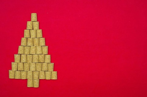 Background with christmas theme, christmas tree with wine corks on red background