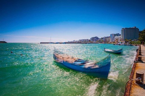 Summer coastal view with boats and hotel buildings in the sunny sky, Golden Sands, Varna, Bulgaria,