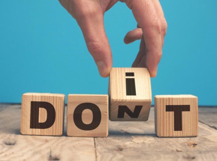 Hand of a businessman with wooden blocks and the words Do it ! Motivational concept