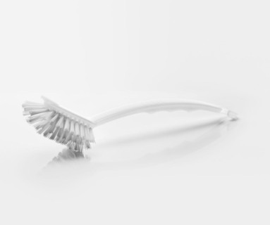 A White clean new dish brush on light grey reflective background