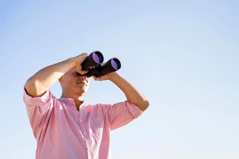 Low angle man watching through binocular