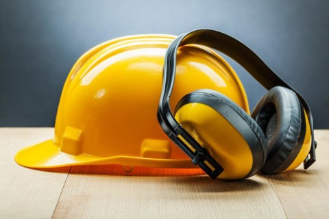 Headphones and yellow construction helmet