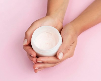 Woman holding face cream box