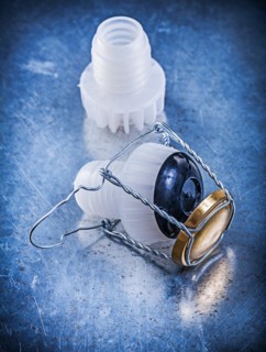 Plastic cork with twisted wire on a metallic background