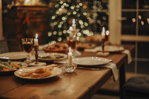 Christmas dinner. The Christmas table is served with a duck, decorated with bright tinsel and