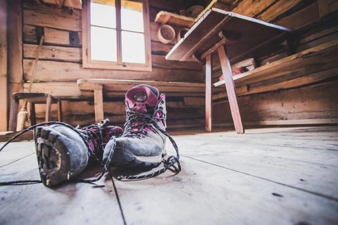 Alpine boots inside of a rustic mountain chalet, Austria, Europe