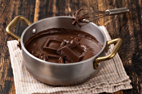 Liquid chocolate cream. Dark background