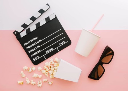 Top view movie clapperboard with popcorn