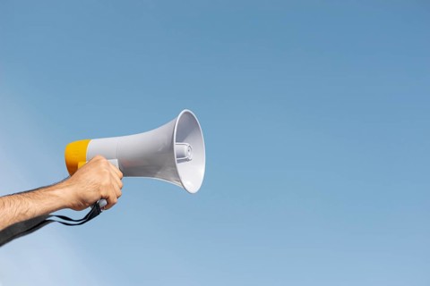 Protester holding megaphone demonstration. High resolution photo
