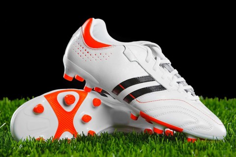 Soccer shoes on the green grass. Closeup