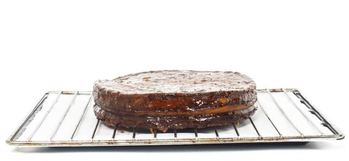 Half stage on sacher torte chocolate cake on grid before chocolate icing towards white