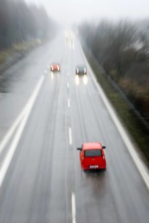 Ghost driver in red small car driving wrong direction on freeway, Autobahn near Munich, Bavaria,