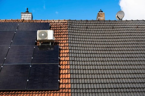 Roofs of a semi-detached house with and without solar panels in Essen, Germany, Europe