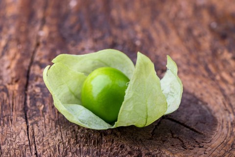 Closeup of a tomatillo on a chopping board