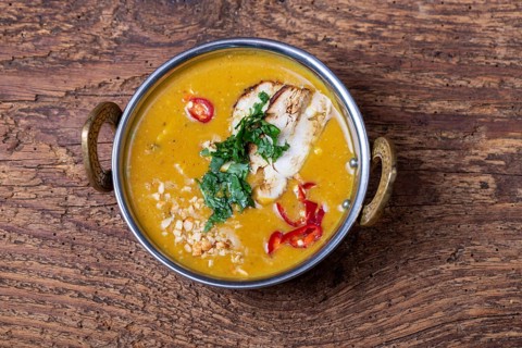Indian mulligatawny soup in a bowl of brass