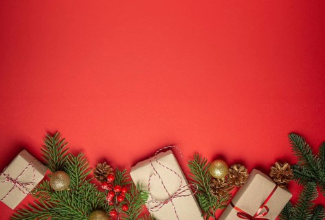 Christmas or New Year celebration red paper festive background with decoration fir tree, wrapped