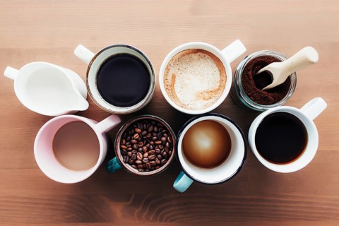 Multiple coffee cups and multicolored mugs with americano, espresso, latte and cappuccino, milk