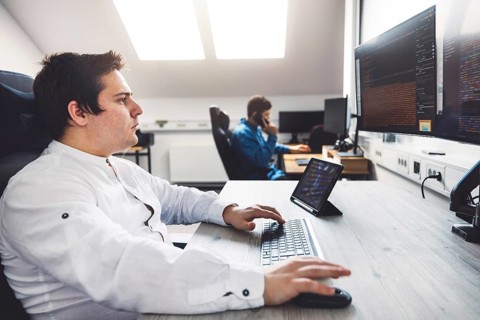 IT Programmer Working on Desktop Computer. Male Specialist Creating Innovative Software Engineer