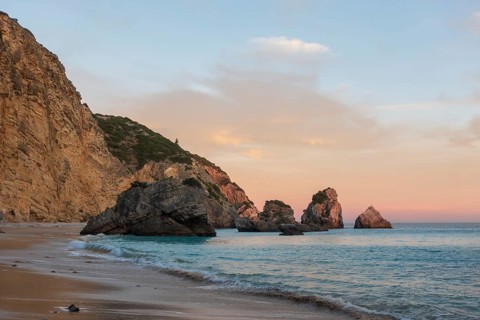 Ribeiro do Cavalo paradise beach in Arrabida Natural Park in Sesimbra at sunset, Portugal, Europe