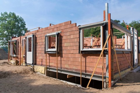 Construction site with walls and windows of new home