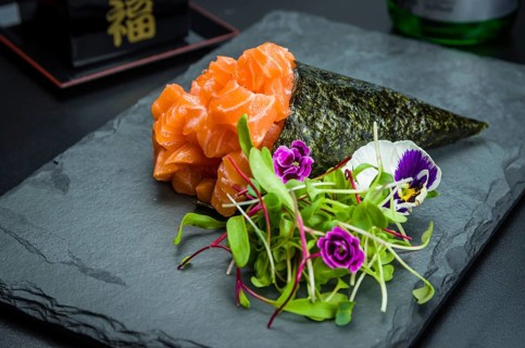 Sushi. Traditional Japanese cuisine, premium salmon Temaki decorated in an elegant setting
