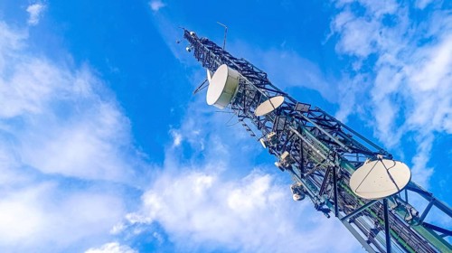 Communication tower with antennas prepared for mobile phones and internet with a blue sky in the