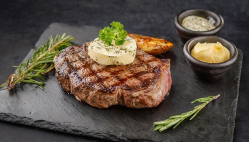 KI generated, A steak with herb butter served on a slate