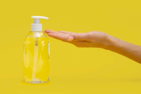 Side view hand using liquid soap
