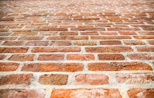 Old red brick wall texture. Selective focus in the center of the photo