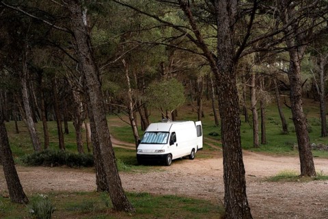 Camper van on a wild spot on a forest