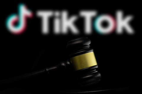 Court gavel in front of the tiktok logo. Tiktok is a short-form video hosting service owned by