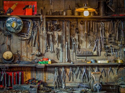 Vintage Tools Hanging On A Wall In A Tool Shed Or Workshop