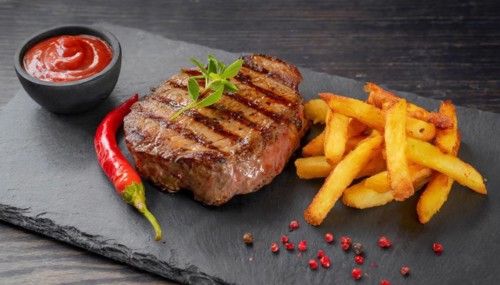 KI generated, A rump steak with fries served on a slate in the restaurant