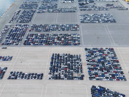 New Cars on Large Half Empty Parking Lot in Port Ready for Distribution. Harbor Car Storage for