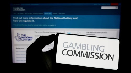 Stuttgart, Germany, 04-01-2023: Person holding cellphone with logo of British public body Gambling