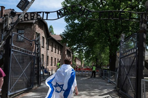 Jude wiith the Israel flag in the German nazi concentration camp Auschwitz Birkenau. Writing over