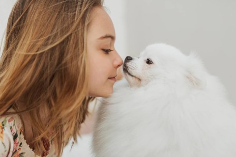 Girl dog touching noses