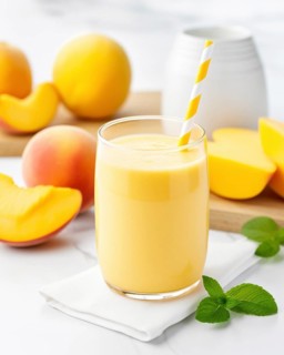 Fresh fruit shake in a glass, exotic fruit, smoothie, milkshake, mango, mint, straw, wellness