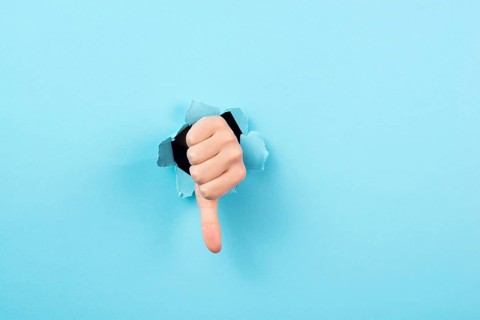 Thumb down, negative hand gesture, dislike or disagree, expression of disappointment, blue torn
