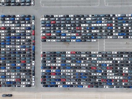 New Cars on Large Parking Lot in Port Ready for Distribution. Harbor Vehicle Storage for Shipping.