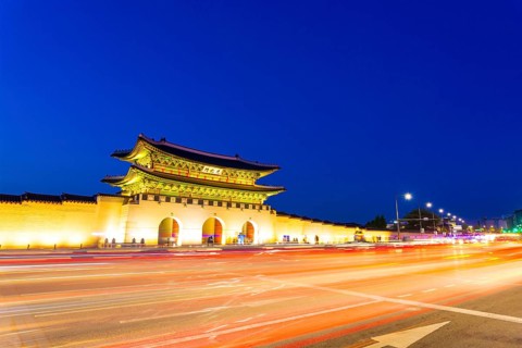 Long exposure streaking car tail lights leaving trailing light in front of Gwanghwamun main gate to