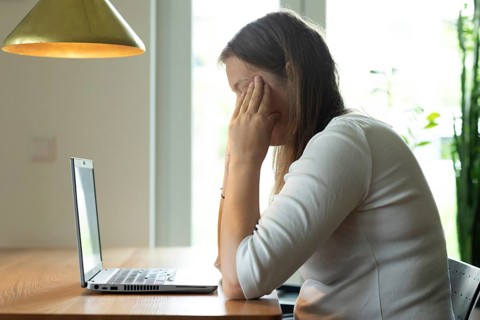 Young woman suffers from burnout in home office on laptop, Freiburg, Baden-Württemberg, Germany,