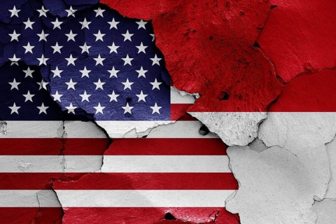 Flags of USA and Indonesia painted on cracked wall