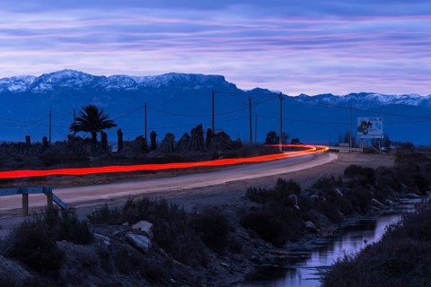 Country road in the Ebro Delta, red tail lights of a car, Catalonia, Spain, Europe