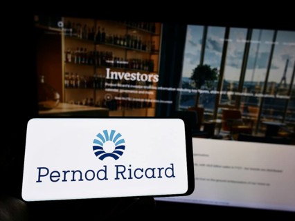 Stuttgart, Germany, 10-14-2022: Person holding mobile phone with logo of French beverage company