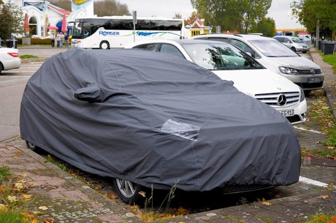 Mercedes, test vehicle covered with cover, parked at motorway service area
