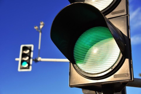 Traffic lights over blue sky. Green light