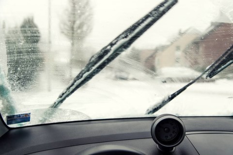 Interior view of a smudged windscreen of a car with windscreen wipers