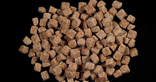 Cane Sugar falling against Black Background